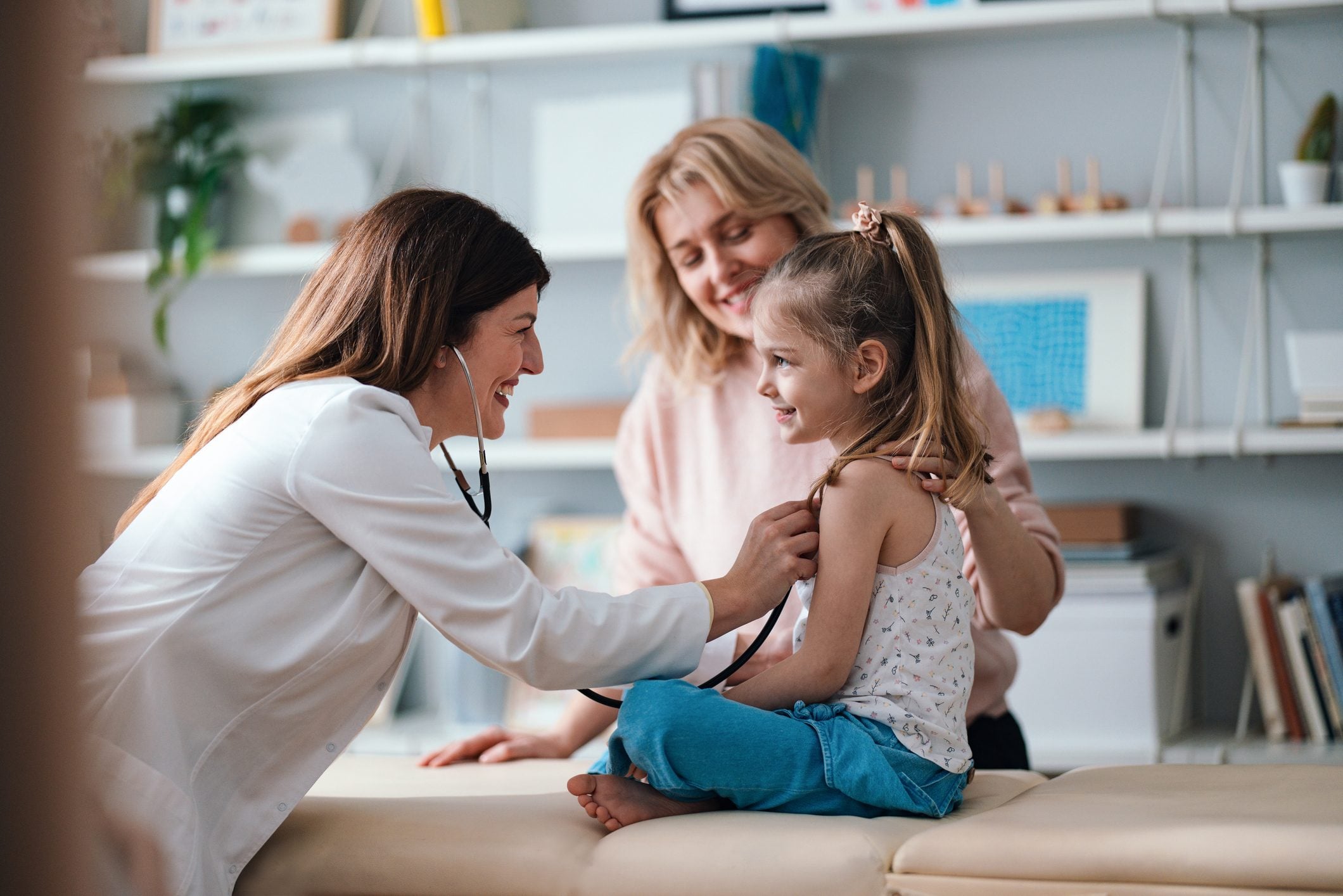 A provider listening to a young patient