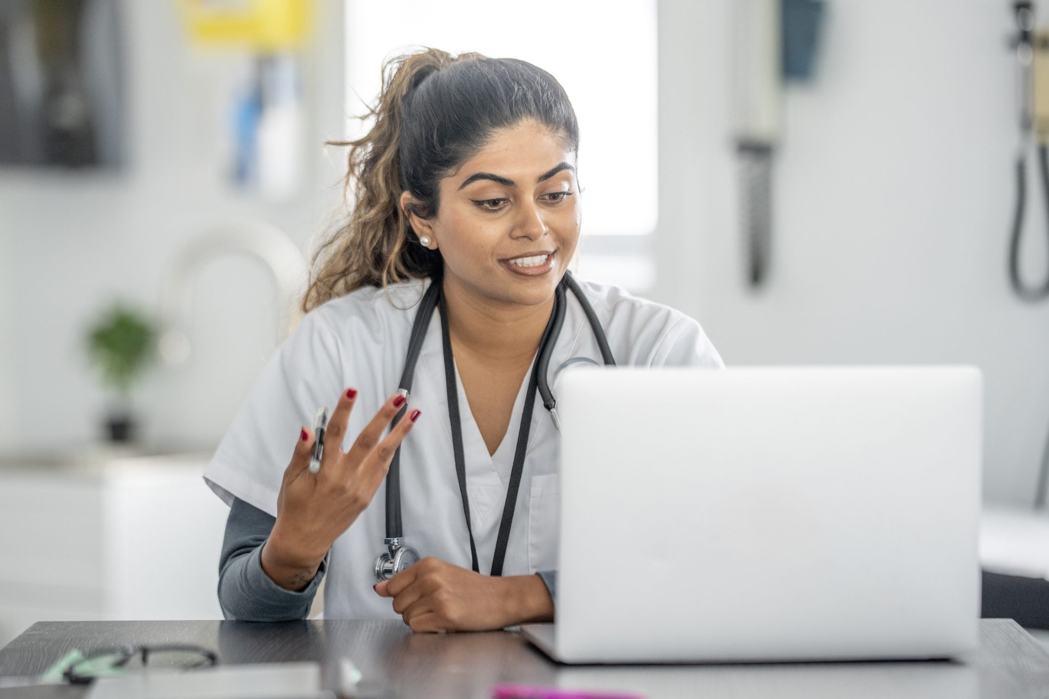 A provider on a call at her desk